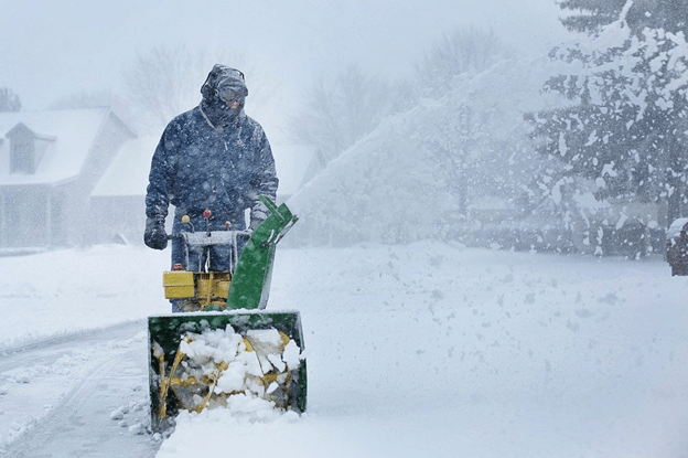 Snow Blower-
A person operating a snow blower with rotating blades